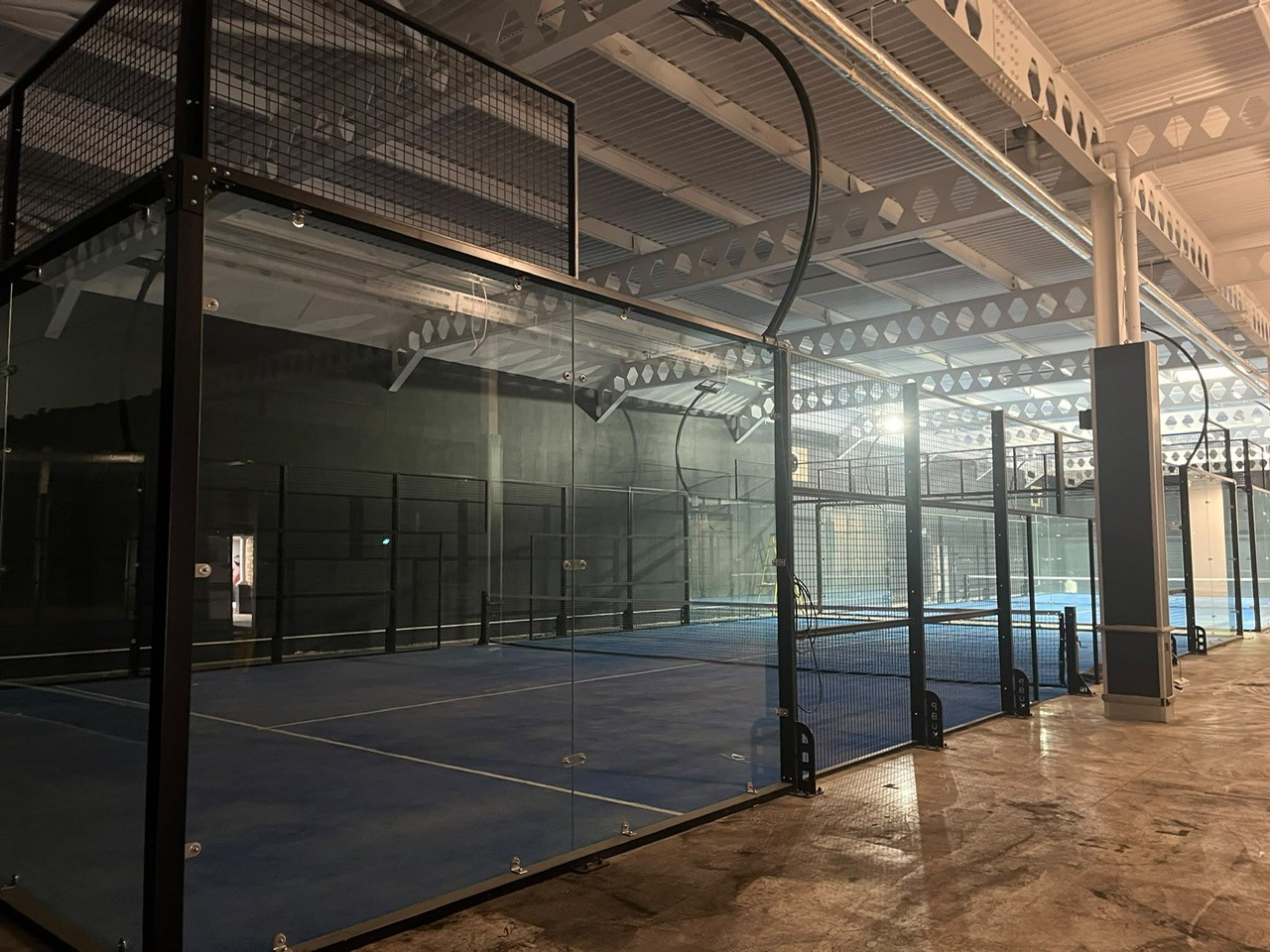 Padel Chippenham's main courts hall coming together — multiple courts, glass and mesh walls installed